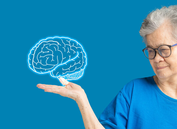 Woman holding a 3D image of a brain in her hand.