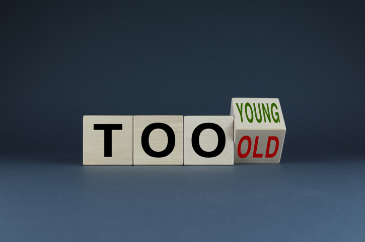 Three cubes with the letters t, o and o and the fourth cube showing the word young as it begins to flip to the word old