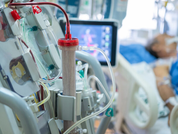 Elderly person hooked up to a dialysis machine