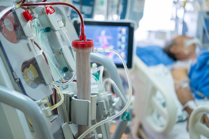 Elderly person hooked up to a dialysis machine